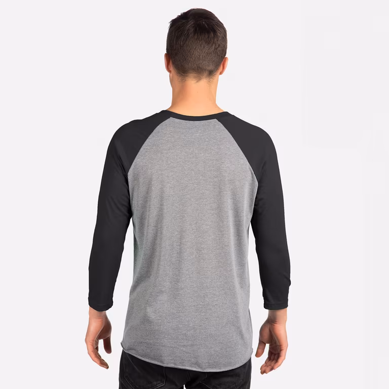 Unisex Triblend Three-Quarter Raglan T-Shirt — Vintage Black Sleeves/ Premium Heather Body, worn